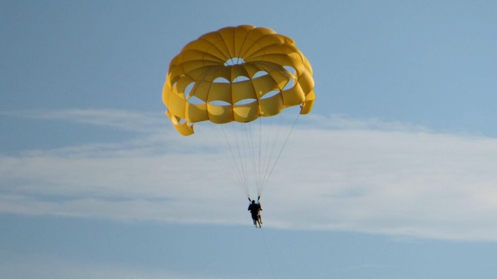 how does air resistance affect the acceleration of a falling parachute